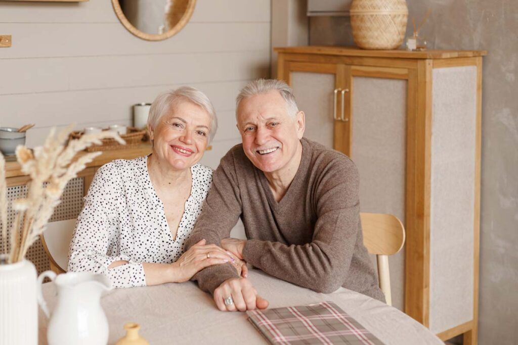 Everlan of Clemson | Portrait of a happy elderly couple sitting in the kitchen