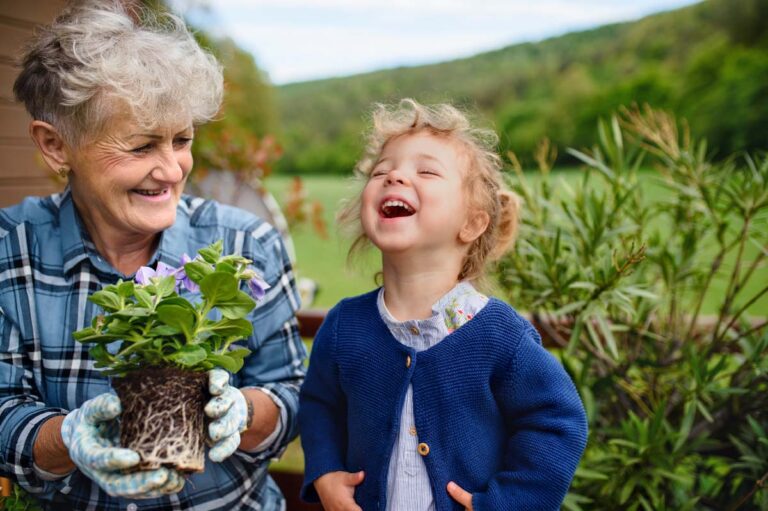 Everlan of Louisville | Senior grandmother with small granddaughter gardening on balcony in summer, laughing