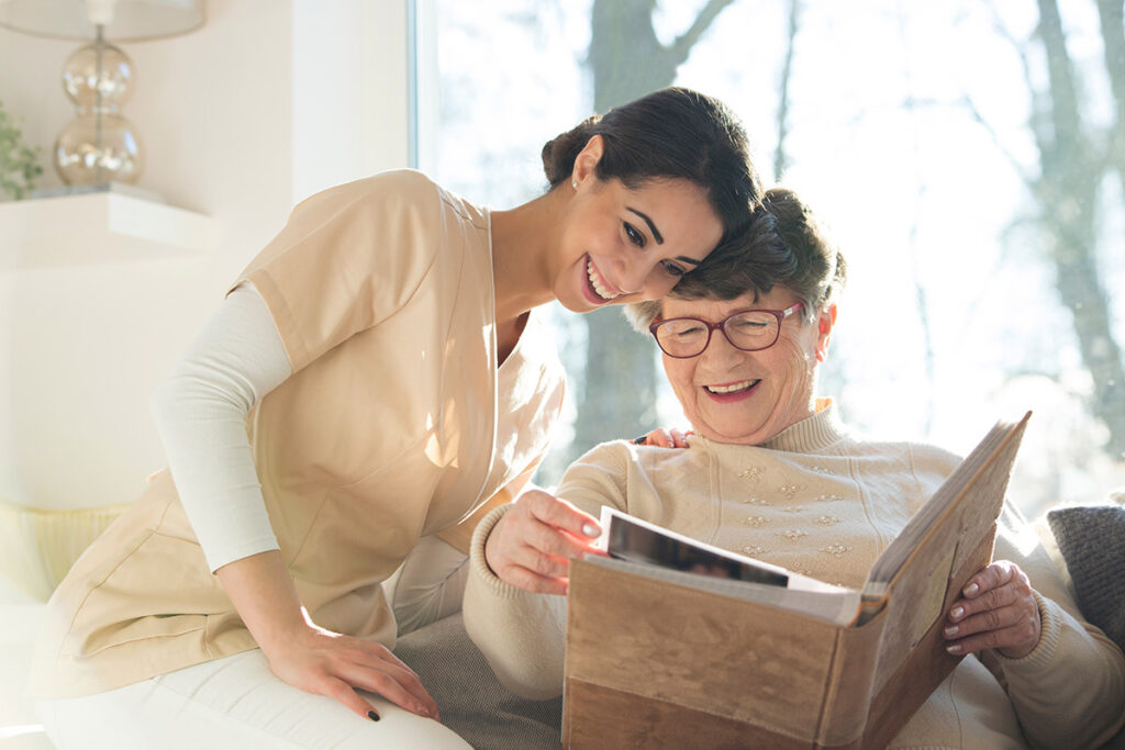 Everlan Senior Living | Smiling senior woman watching photobook