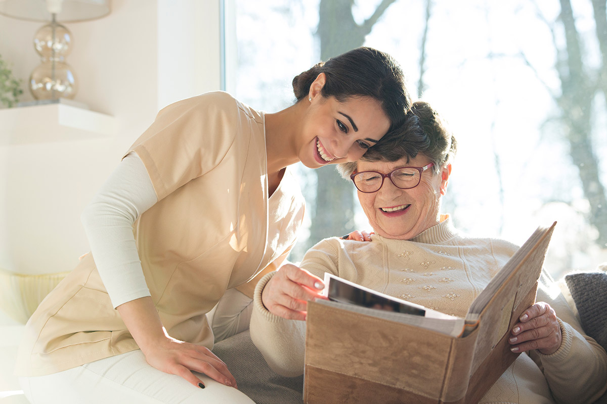 Everlan Senior Living | Smiling senior woman watching photobook