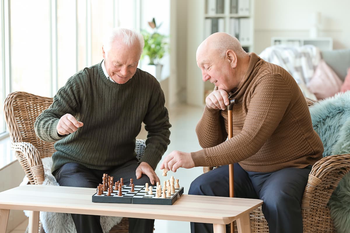Everlan of Louisville | Assisted living Symya - senior men playing chess together