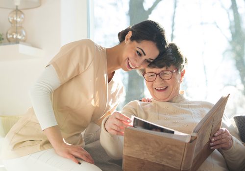 Everlan Senior Living | Smiling senior woman watching photobook